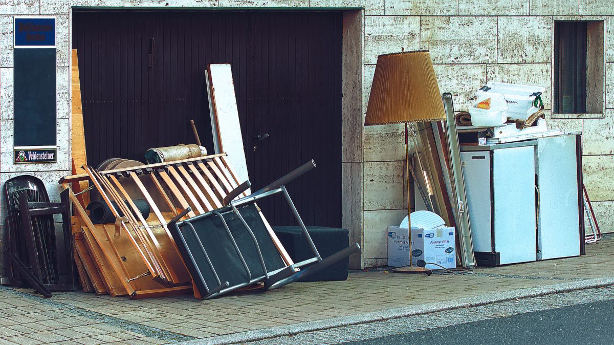 Landscape Photograph of household items laying on the pavement.